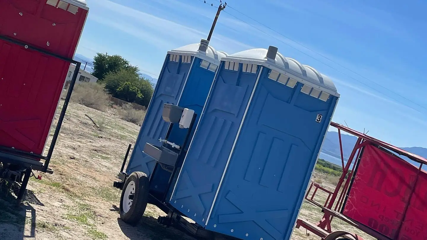 Portable toilets on a transport trailer in a field