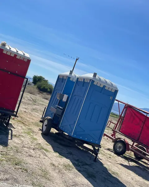 Portable toilets on a transport trailer in a field
