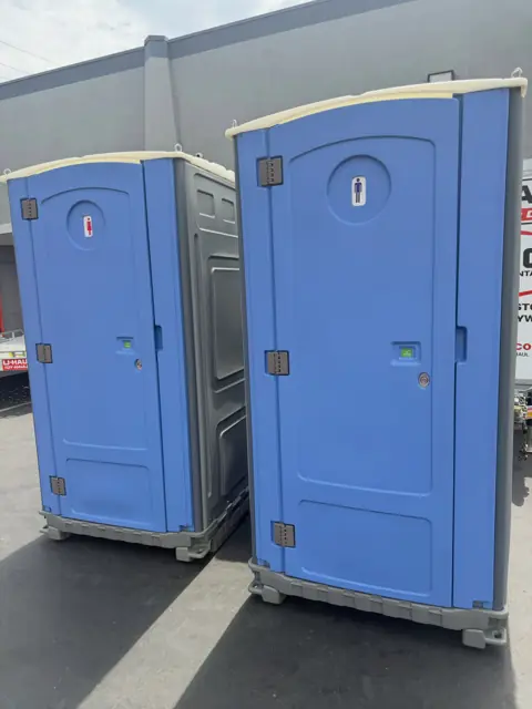 Two blue standard portable toilets
