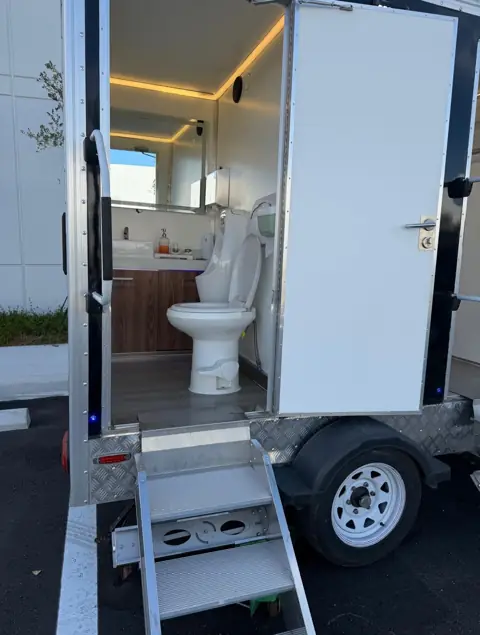 Lit interior of a VIP restroom trailer